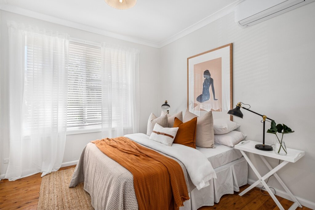 small apartment interior with laundry drying on rack near window in winter