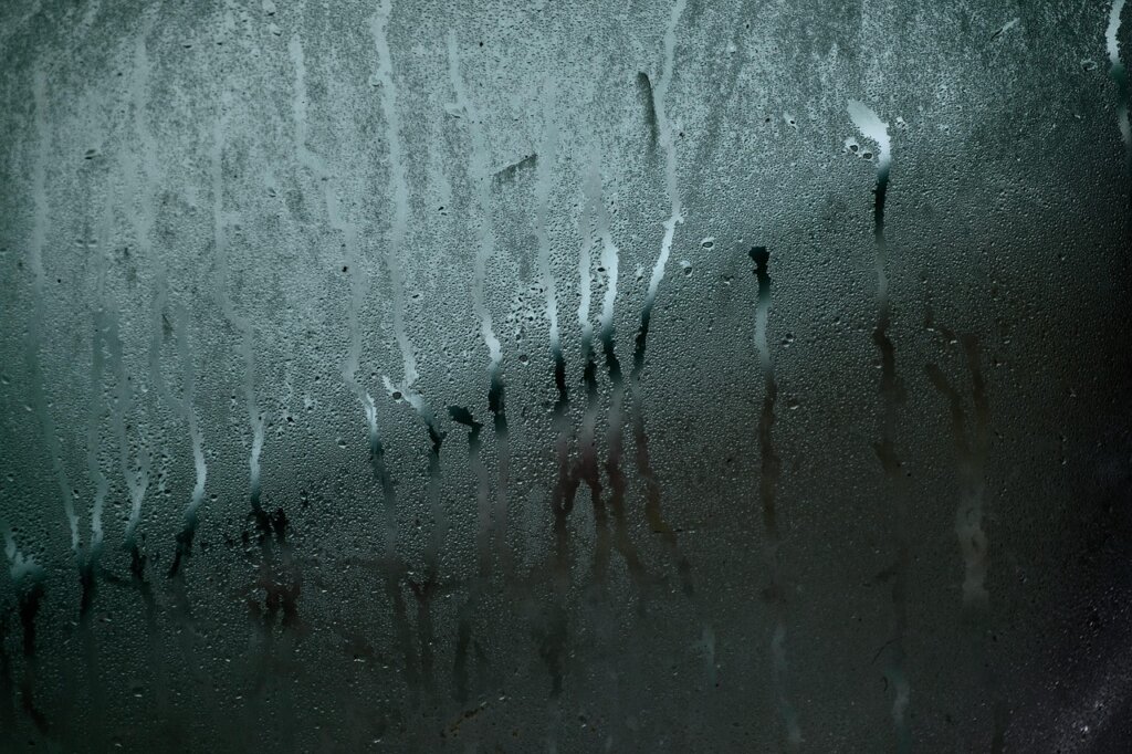 studio apartment window condensation droplets