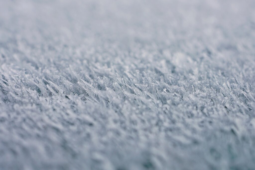 thick frost ice inside freezer compartment close up