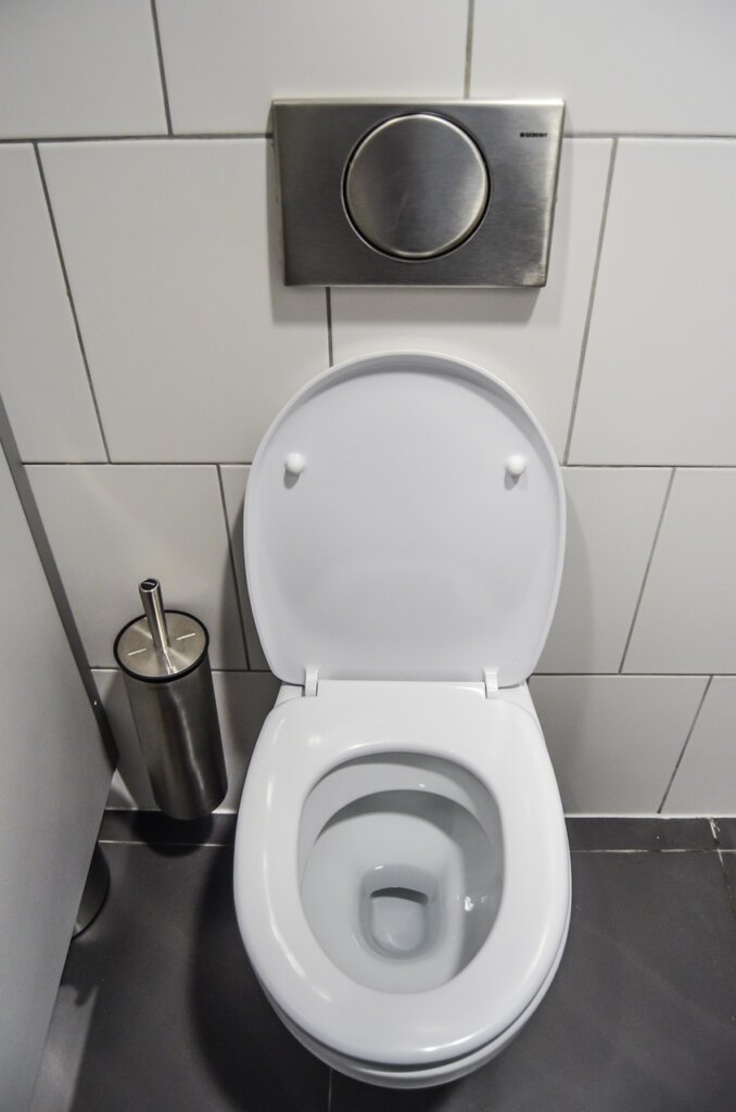bathroom window open with ventilation fan running during toilet cleaning