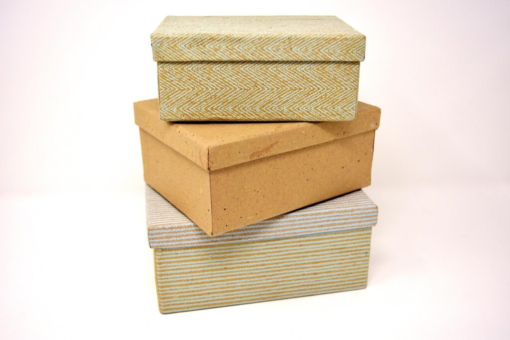 woman sealing cardboard box with packing tape and marker
