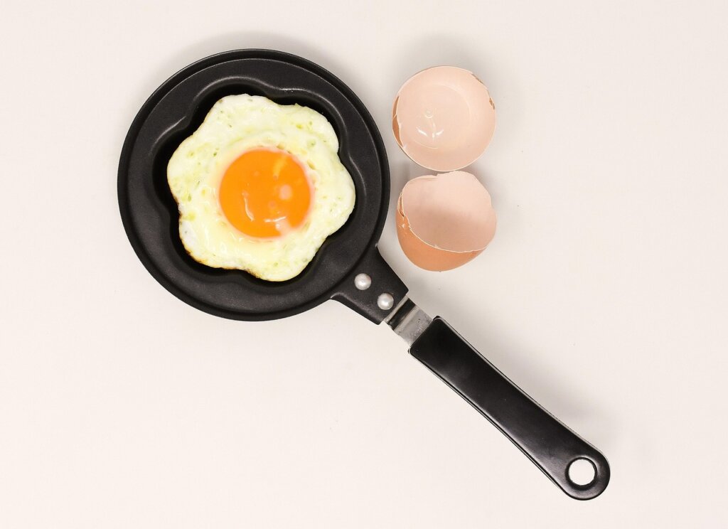 cracked egg on white plate showing yolk condition