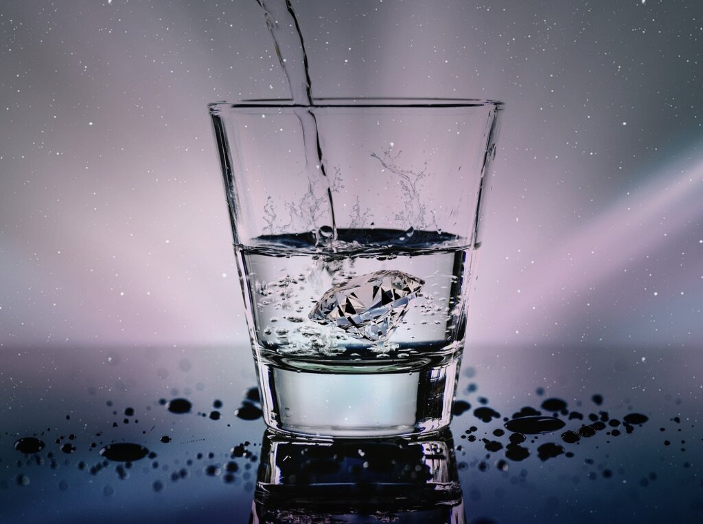 fresh egg sinking in water glass