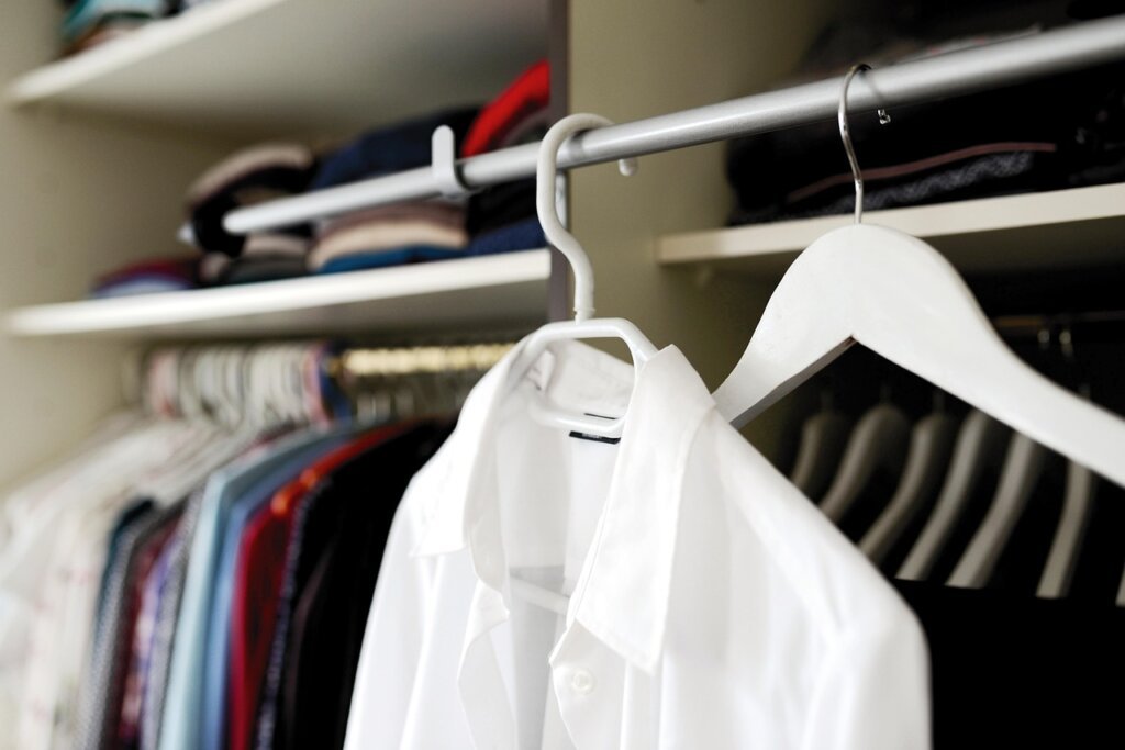 clothes hanging on rack with proper spacing between hangers