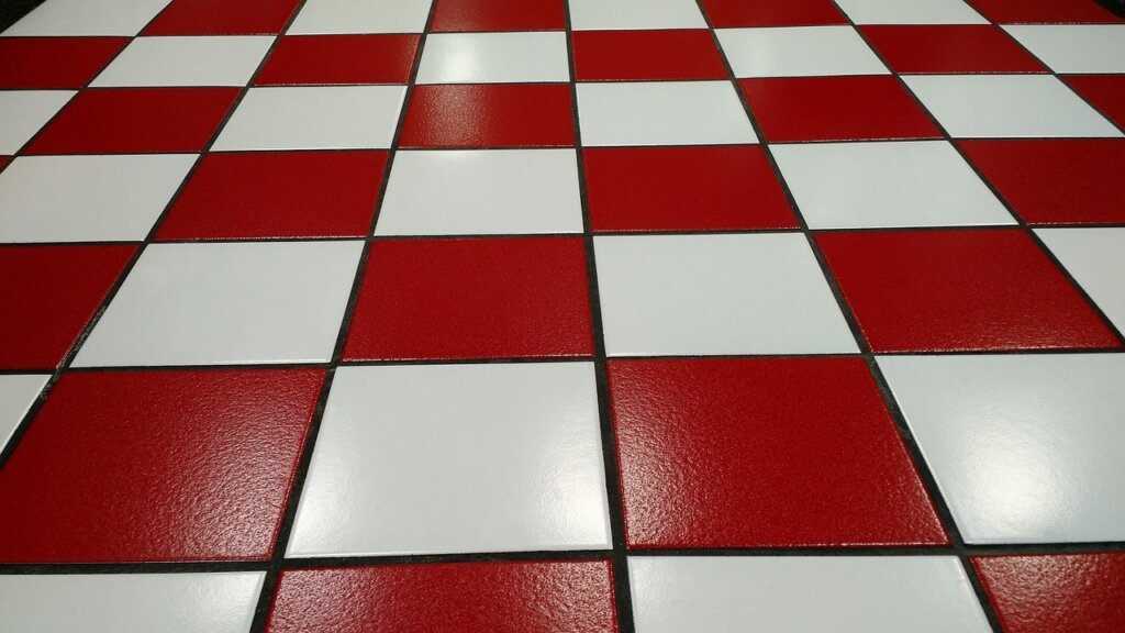 citric acid spray bottle applied on white tile grout