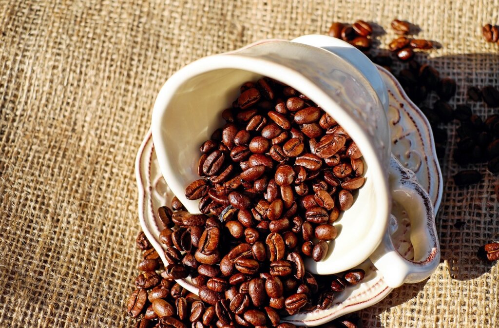person blotting coffee stain on wall immediately after spill