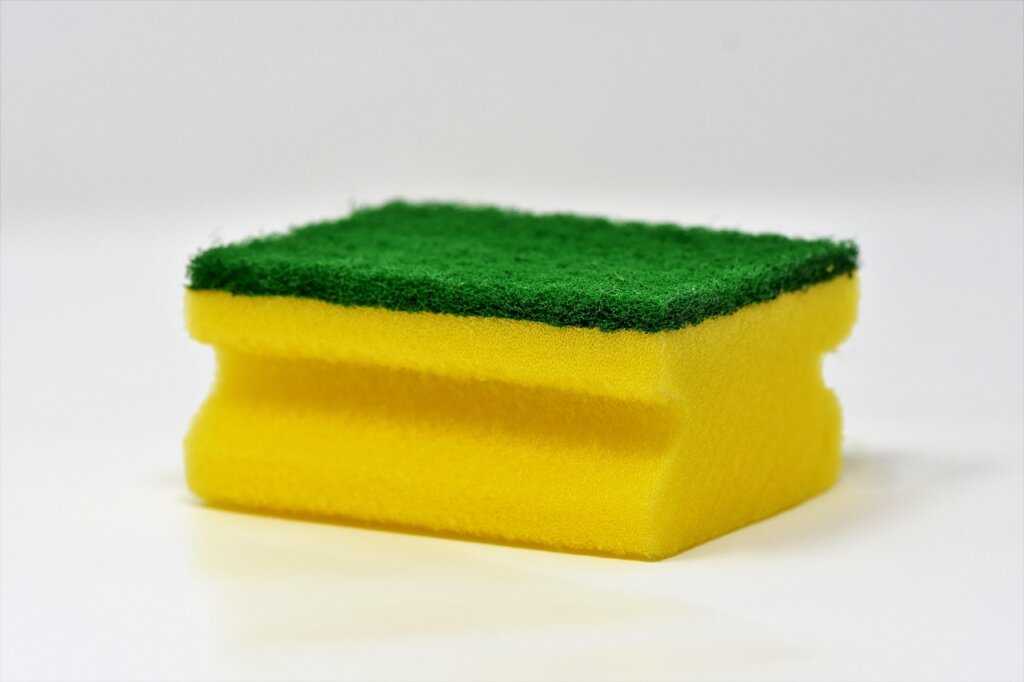 wrong way to clean wallpaper using wet sponge and scrubbing hard