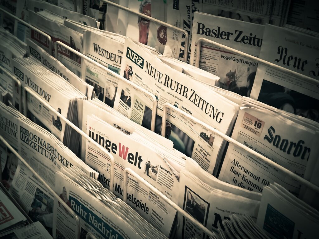 newspaper rolled into stick cleaning window ledge
