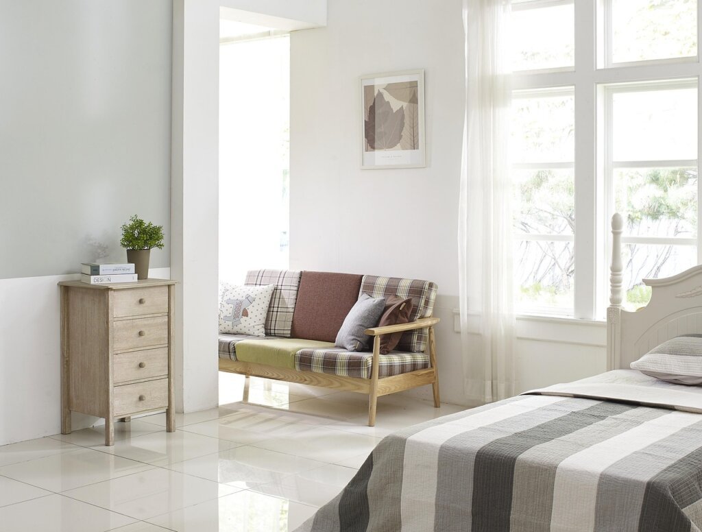 well-ventilated bedroom with sunlight coming through open windows