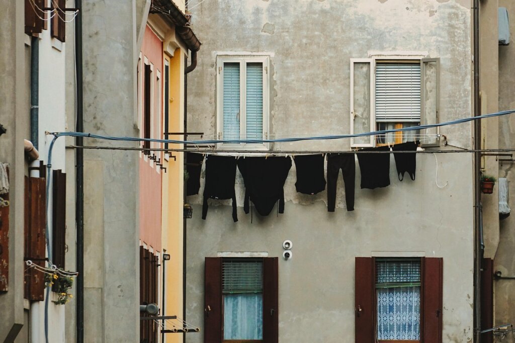 laundry hung with space between garments near window