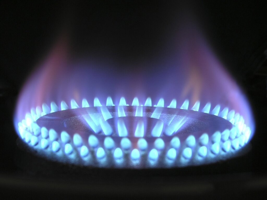 gas stove grate soaking in hot water with oxygen bleach powder
