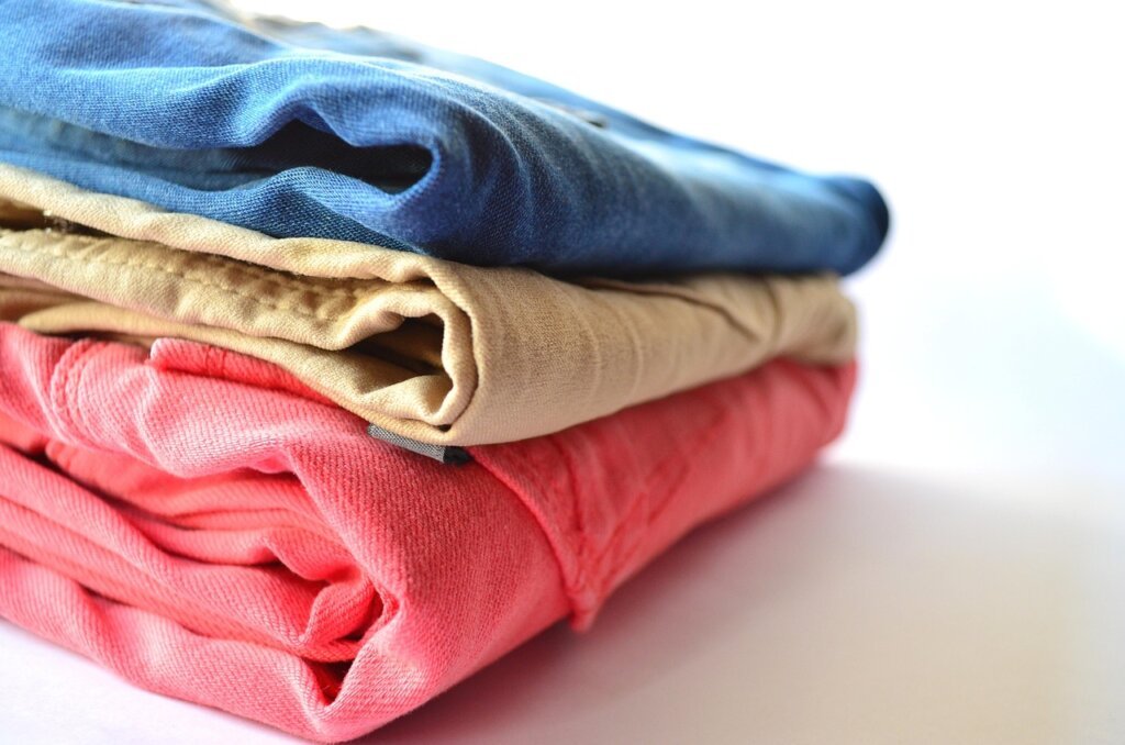 neatly organized wardrobe with clothes spaced evenly and dehumidifier packet visible