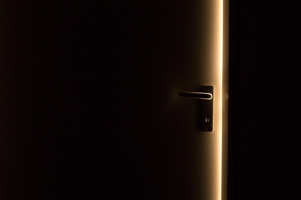person opening wardrobe doors wide to ventilate clothes before business trip