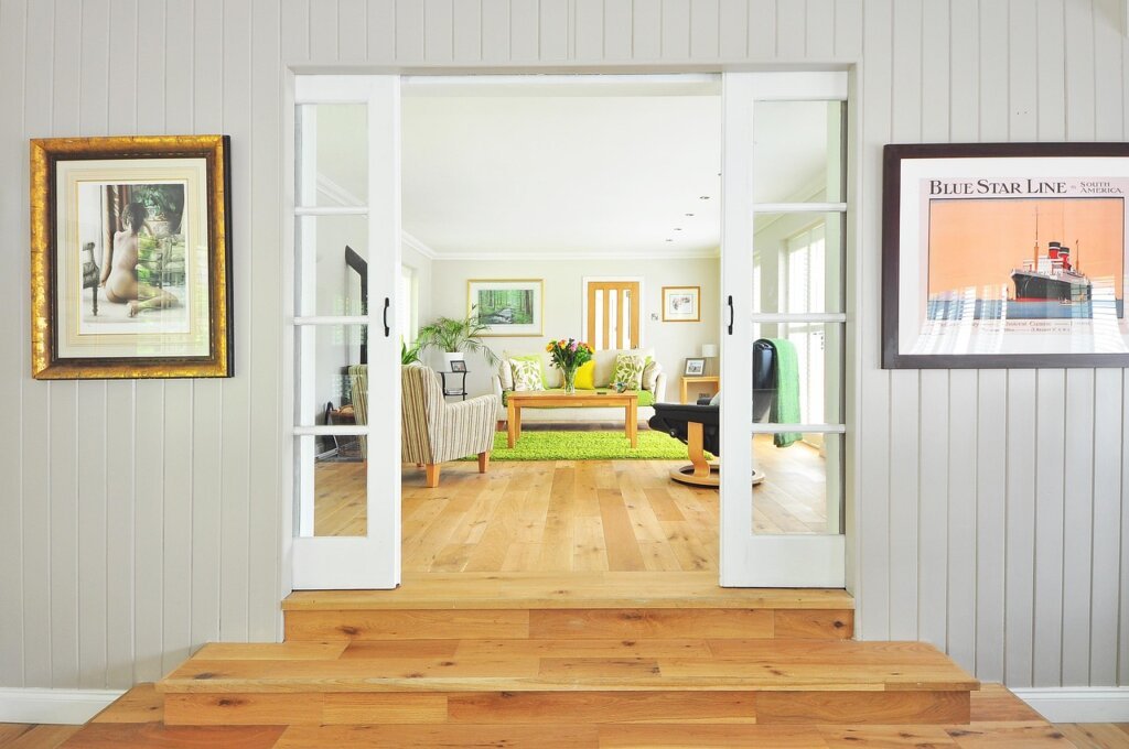 electric spin mop cleaning hardwood floor in bright living room apartment